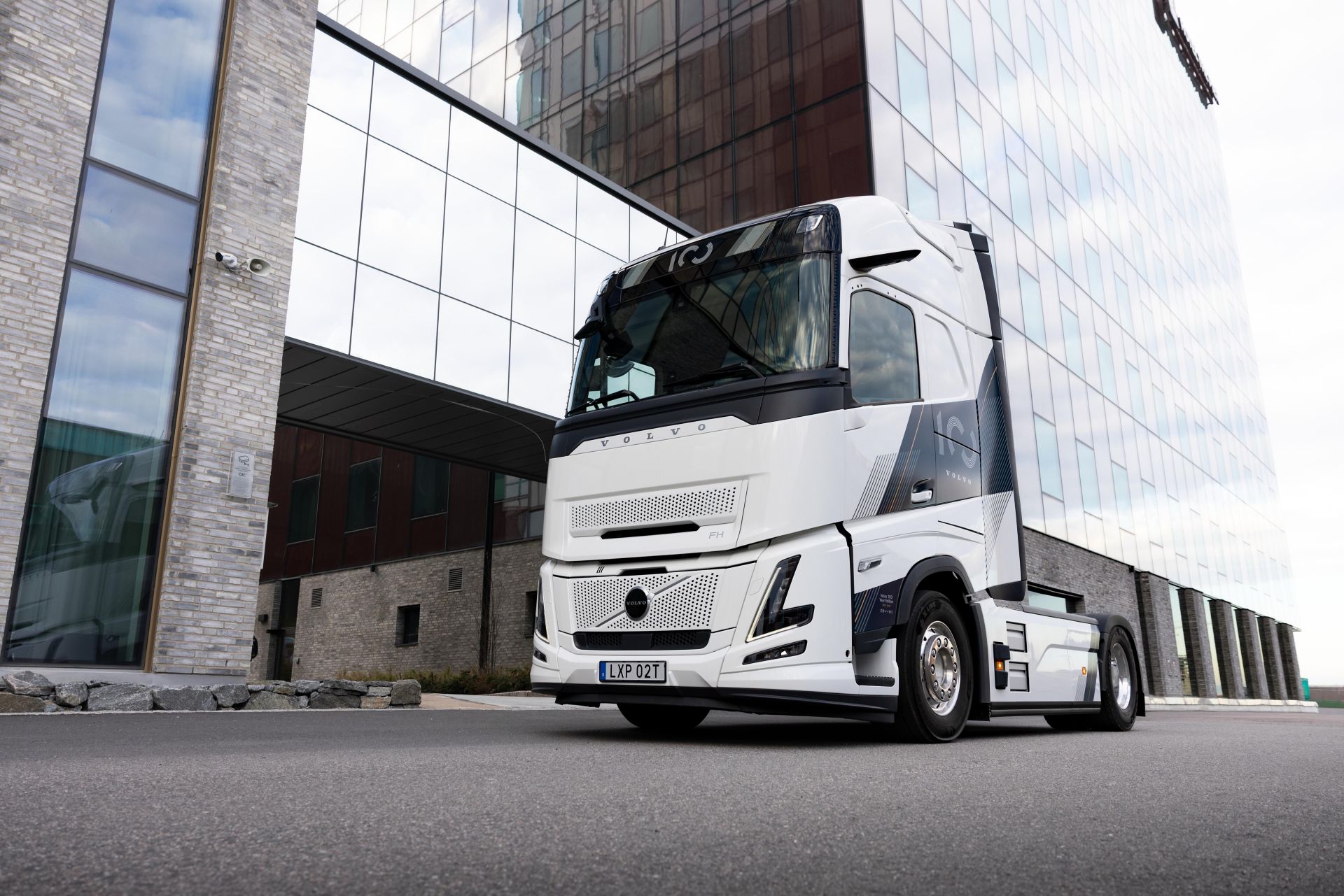 Volvo FH 100 Year Edition outside a modern building.
